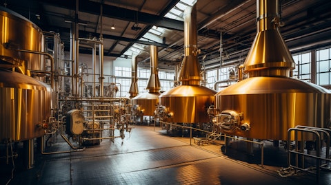 A wide-angled shot of a brewery showing the large machinery used for producing malt beverages.
