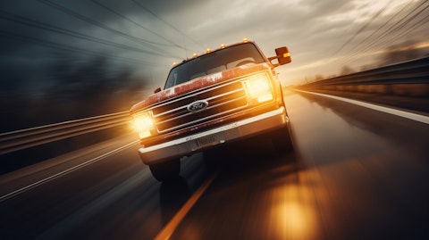 A Ford truck roaring down a highway, with powerful headlights blazing its way.