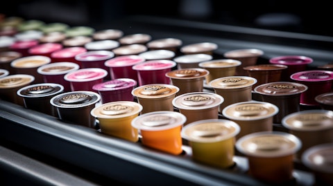 A conveyor belt filled with assorted K-Cup pods, ready for packaging.
