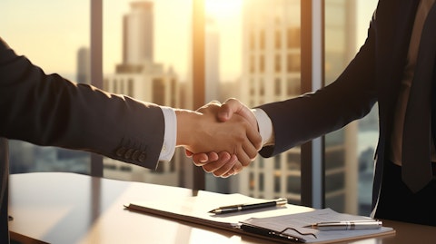 A business executive in a sharp suit shaking hands on a real estate deal.