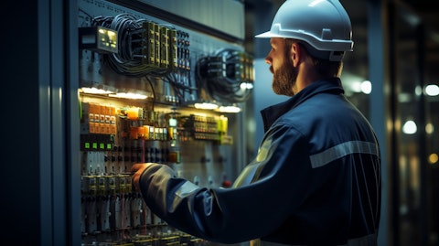 Close up image of an engineer inspecting the control panel of a modern power plant.