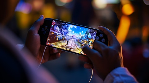 A close up of a consumer enjoying the company's games on their mobile device.