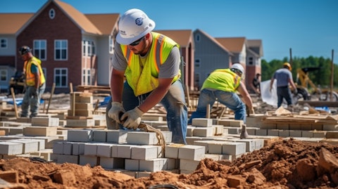 Construction workers laying bricks during the residential development of multiple lots.