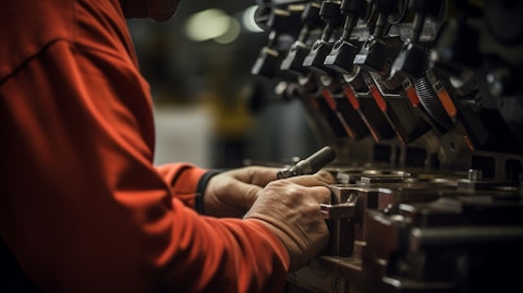 A close-up of a technician's hands making precision adjustments to a specialty industrial machine.