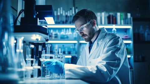 A research scientist in a laboratory holding a vial of a biotechnology drug.