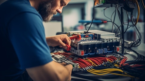 A close-up of a technician assembling a complex wiring harness for a building product.