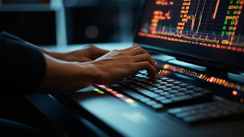 A close-up of a nerds hands using a keyboard to place a stock trade in real-time.