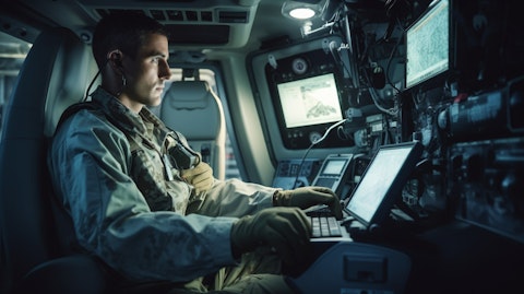 A technician in a white coat testing an in-car system on a modern military vehicle.
