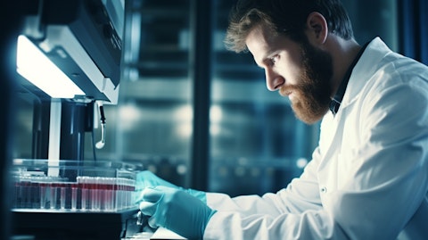Analysing a blood sample, a technician in a lab coat using precision diagnostic equipment.