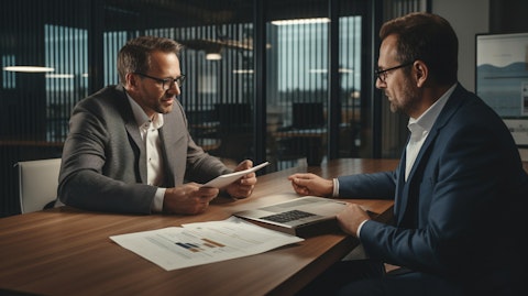A financial advisor demonstrating a product to a corporate client in an office.
