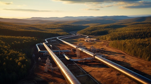 An aerial view of a large natural gas transmission pipeline network in an industrialized landscape.