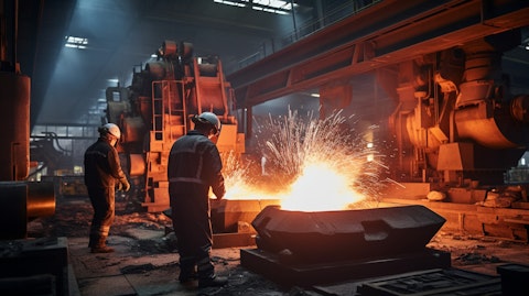 Industrial workers carrying out the complex production process of alloy ingot at a factory.