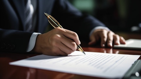 An individual signing the dotted line for a life insurance policy.