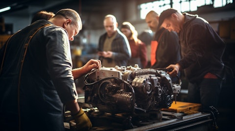 A line of mechanics diagnosing a recreation vehicle engine at a repair shop. 