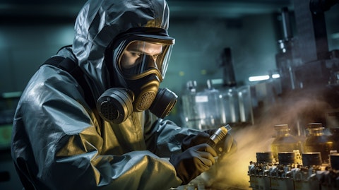 An industrial worker in a protective suit operating a complex chemical process.