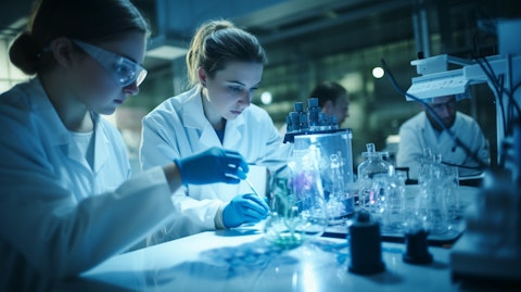A team of scientists in a laboratory examining a tube containing a monoclonal antibody.