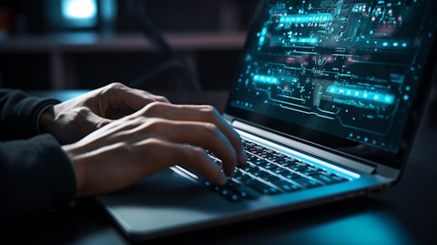 A close-up picture of a software engineer typing code on a laptop.