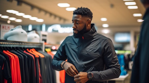 A customer trying on a sports jacket in-store, showcasing the company's sportswear range.