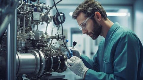 A worker in a laboratory coat checking a Positive Displacement Pump.