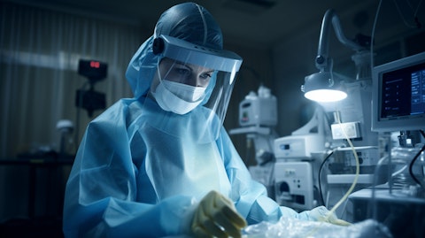 A nurse in a hospital room, administering a procedural medical product in an infection prevention setting.