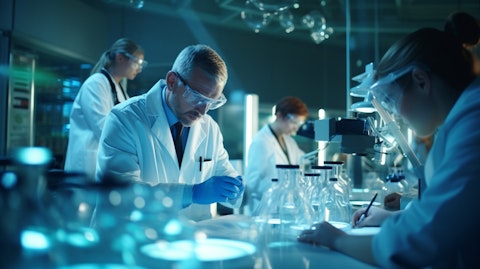 A team of scientists in lab coats surrounded by pharmaceuticals and medical equipment, researching a life-saving oncology-focused biotechnology.