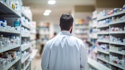 A pharmacist at a local store, stocking shelves with products from the consumer health company.