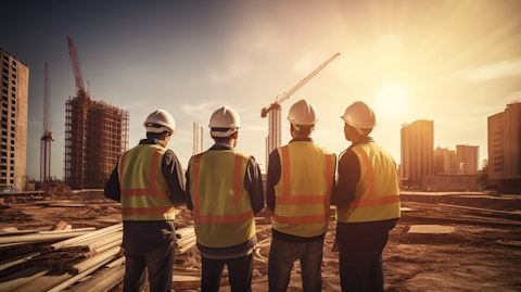 A team of construction workers with their order of industrial supplies, on a construction site.