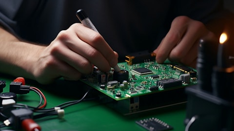 A close-up of a technician's hand assembling an electrical device.
