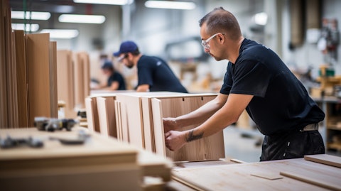 A team of employees assembling cabinets in the company's factory.