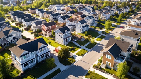 An aerial view of a neighborhood, showing newly constructed homes in a cul-de-sac.