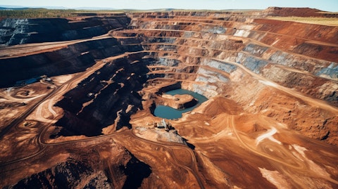 Aerial view of a giant iron ore mine, showcasing the mineral deposits of the company's Ferrous Minerals segment.