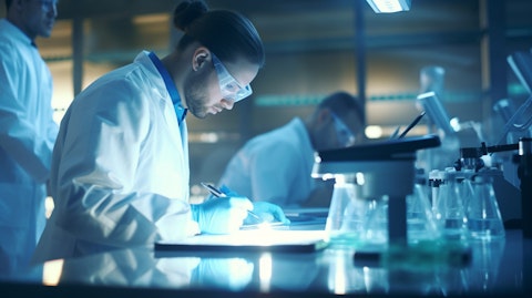 A team of medical professionals in surgical scrubs analysing research data in a laboratory.