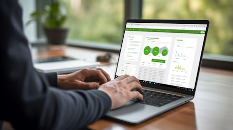 A close-up of a hand holding a laptop, showing the user navigating their Upwork platform dashboard.