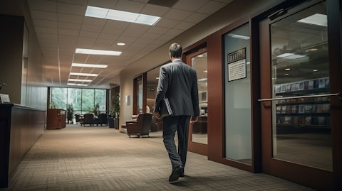 An executive in a suit walking through an insurance office.