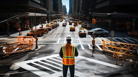 A municipal worker standing in the middle of an automated safety intersection to ensure its proper operation.