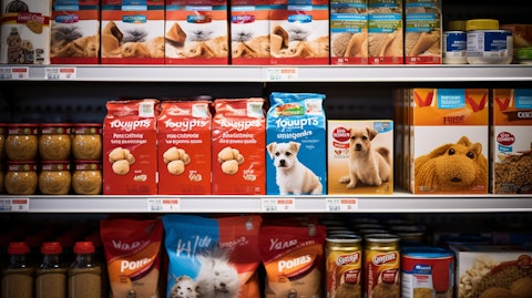 A close-up shot of a store shelf stocked with pet food and supplies.