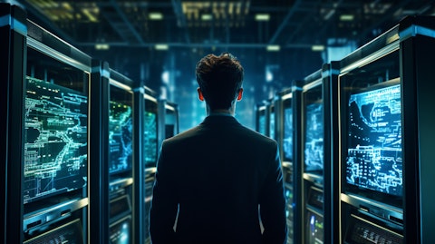 A network engineer gazing intently at computer monitors, surrounded by servers and storage systems.