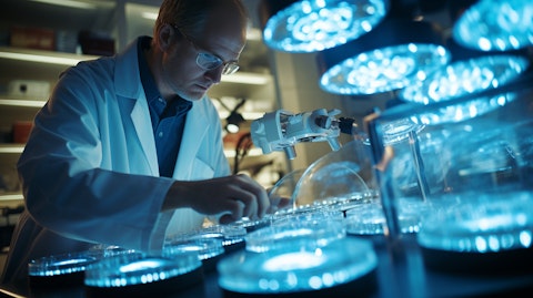 A scientist in a lab coat analyzing a Petri dish surrounded by scientific equipment in a research lab.