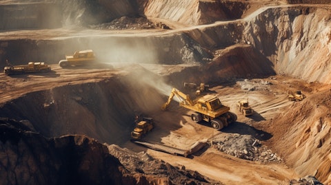 Aerial view of an open pit mine, with workers extracting minerals.