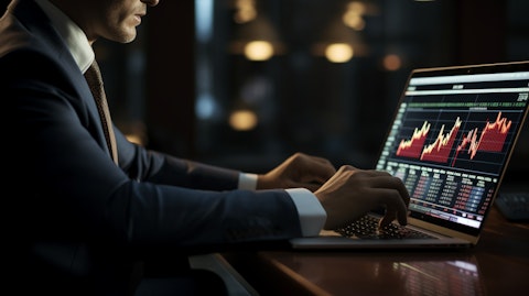 A businessperson in a suit typing on a laptop, making financial decisions.