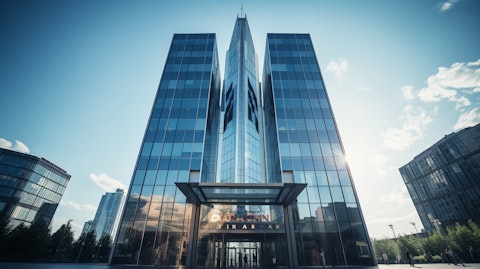 A high-rise office building with the company's logo prominently displayed in the center of the facade.