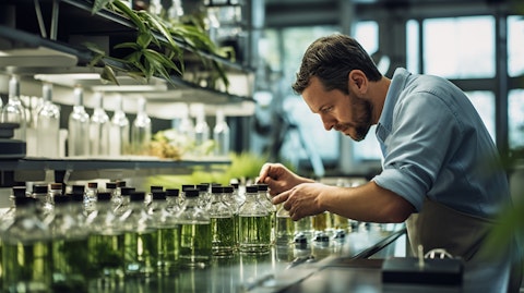 A technician filling bottles with nature-based ingredients for the company's personal care products.
