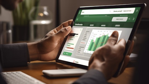 A close up of a hand pressing a mobile banking app displayed on a tablet or smartphone.