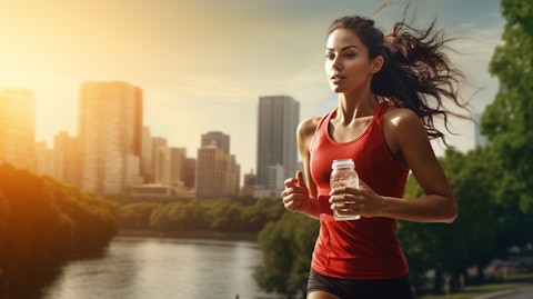 A person enjoying a morning jog while sipping from a bottle of a functional beverage.