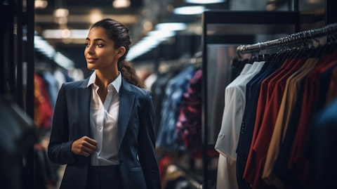 A proud woman in business clothing, standing in a modern store stocking up on women's apparel.