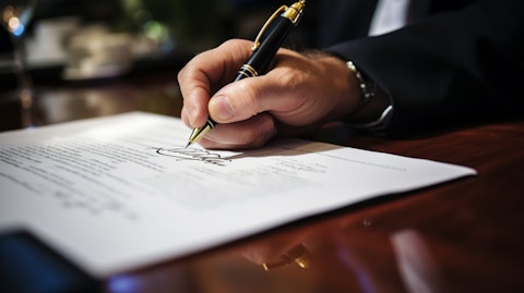 A closeup of a hand signing a life insurance policy, illustrating the security it provides.