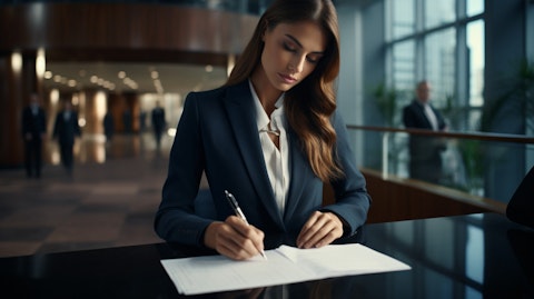A woman signing a mortgage loan in a modern banking hall.