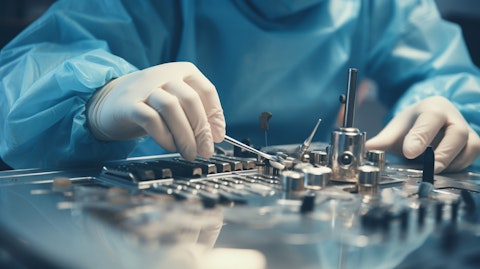 A close-up of a surgeon's hands manipulating a medical instrument during a surgery.