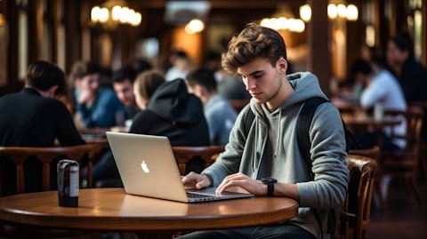 A student, their laptop open, using the companies learning platform.