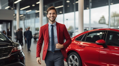 A customer smiling delightedly after driving away in their new car from the automotive retail shop.